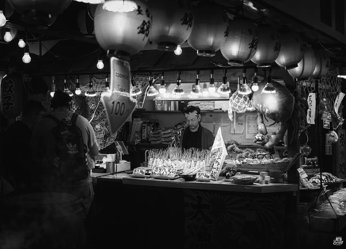 The covered arcade of Nishiki Market in central Kyoto with its striped roof panels