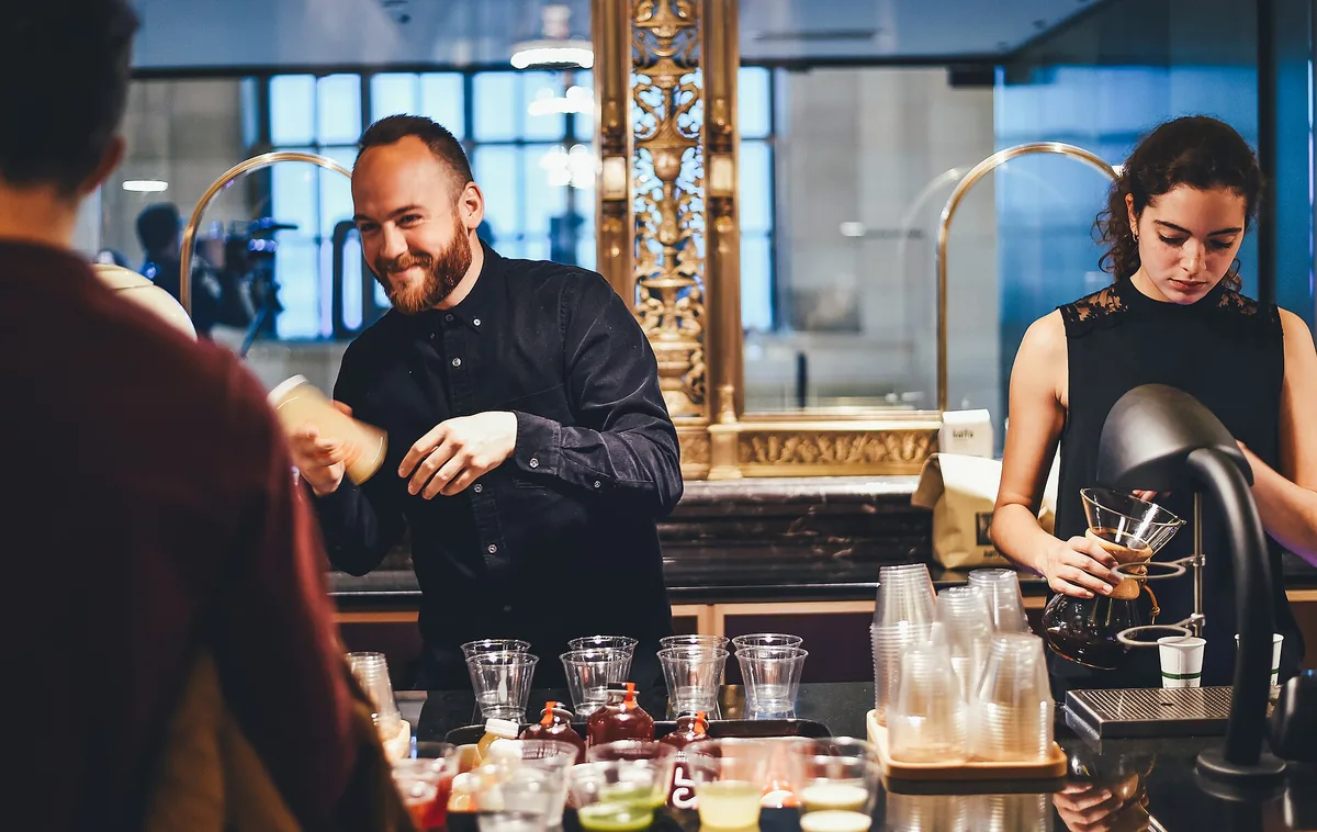 A cocktail on a marble counter in a high-floor hotel bar overlooking Tokyo